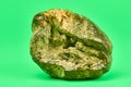 Rotten lemon, green background