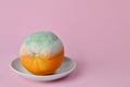 Rotten orange. Rotten moldy orange in a plate on pink background. A photo of the growing mold. Food contamination, bad spoiled Royalty Free Stock Photo