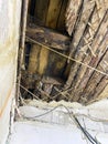 A rotten roof, a hole in the roof of the building.