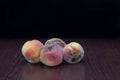 Rotten spoiled peaches on a black background Royalty Free Stock Photo