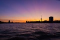 Rotterdam harbor at magenta colored sunset: view on the Euromast and Delfshaven area silhouette. Harbor cranes in the far distance Royalty Free Stock Photo