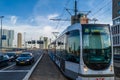 Urban scene, street with cars and a tram with skyscrapers in the background in Rotterdam, the Netherlands