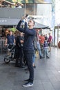 Caucasian male holding up a mobile phone to take a tourist sightseeing photography