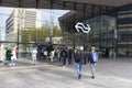 Entrance to large modern railway station with symbol for dutch railways