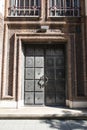 External facade of old building showing an ornate double door. Historic design