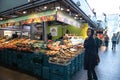 Inside market hall showing food court area with fruit and vegetable stall