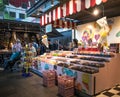 Inside market hall showing food court area with sweet confectionary candy stall