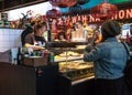 Inside market hall showing food court area with take away oriental chinese asian food vendor