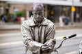 Rotterdam, the Netherlands - March 26, 2023: Sculpture of a man on a city street in the rain