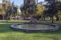 Old fountain in park with bronze statue of three dancing women