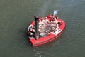 Tourists customers having fun in a Hot Tug boat in a river canal