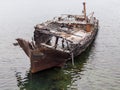 Rotting, abandoned ship on a water of sea, a symbol of decadence and degradation