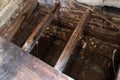 Rotton broken floor joists exposed during home renovation with flooded house foundations