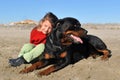 Rottweiler and child on the beach Royalty Free Stock Photo