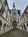 Rouen, France - June 2019: multicolored timber framing buildings on the streets of summer Rouen, Normandie. People on excursion