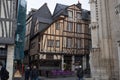 Rouen. Old and tilted houses at Rue Eau de Robec on a rainy day. Rue Eau-de-Robec is one of the main tourist streets of