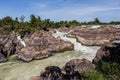 Rough and abundant river white flowing at rock side