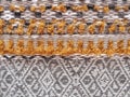 Rough background of white and ocher fabric and orange embroidery. Texture of cotton and wool textiles. knitted background texture Royalty Free Stock Photo