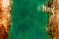 Rough and battered green paint texture on a rusted metal surface showing scratches, dents and rust patches Royalty Free Stock Photo