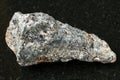 rough biotite nepheline syenite stone on dark