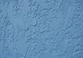 Rough blue stucco wall with a textured surface. The uneven plaster Royalty Free Stock Photo