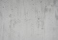 Rough concrete wall surface with uneven texture and small holes. Vertical streaking patterns and Royalty Free Stock Photo