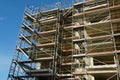 Rough construction of a new residential building covered by scaffolding. High capacity residence solution as a cheap solution.