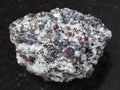 Rough corundum crystals in gneiss stone on dark Royalty Free Stock Photo