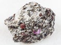 rough corundum crystals in gneiss stone on white