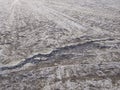 Rough cracked asphalt texture. Perspective of Old damaged cracked asphalt road surface. Background and pattern. Water erosion of