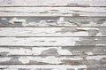 Rough crackled paint on wooden boards, white color paint peeling off.