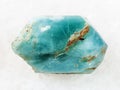 rough crystal of blue apatite gemstone on white