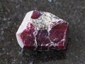 rough crystal of red garnet gemstone on dark Royalty Free Stock Photo