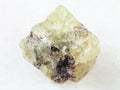 rough crystal of Saamite (fluorapatite) on white