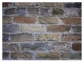 Rough hewn chiseled red brick wall for abstract, textured background.