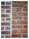 Rough hewn chiseled red brick wall for abstract, textured background.