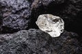 Rough diamond, uncut gemstone, mine bottom. Concept of mining and extraction of rare ores Royalty Free Stock Photo