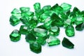 rough emeralds scattered on a white table Royalty Free Stock Photo