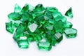 rough emeralds scattered on a white table Royalty Free Stock Photo