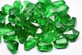 rough emeralds scattered on a white table Royalty Free Stock Photo