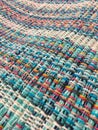 Rough fabric is woven of threads of different colors. Textile background.