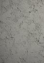 Rough grey concrete wall featuring an irregular texture with scattered small cracks a Royalty Free Stock Photo