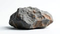 Rough grey rock with rusty orange patches sits isolated on clean white background. Stone surface shows deep texture, sharp Royalty Free Stock Photo