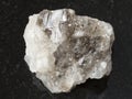 Rough Halite rock salt stone on dark