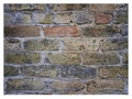 Rough hewn chiseled red brick wall for abstract, textured background.