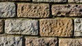 Rough hewn stone wall featuring irregular rectangular blocks Royalty Free Stock Photo