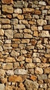 Rough hewn stone wall texture with weathered irregular rocks and mortarless construction Royalty Free Stock Photo