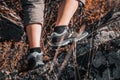 Rough hiking boots on rocky stones in mountains. Climbing uphill Royalty Free Stock Photo