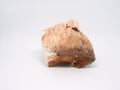 Rough mineral stone red gypsum on white background closeup