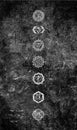 Rough monochrome background on a stone wall with the symbols of the seven chakras, black white, spiritual healing
